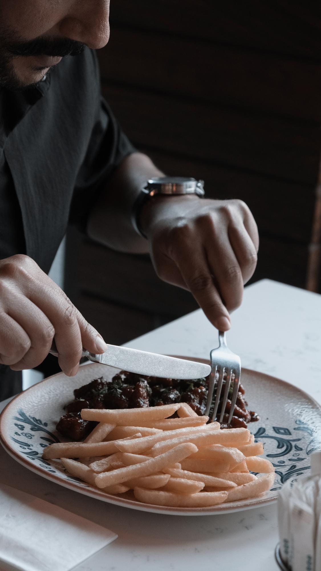 Chef arranging plated dessert in luxurious kitchen
